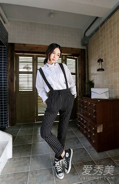 学院风格的条纹束带裤被巧妙地穿着，以减少年龄和显示出苗条。